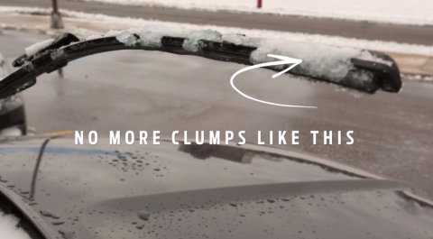 A close-up image of a car's windshield wiper with clumps of snow and ice on it. An arrow points to the clumps with the text 'No more clumps like this,' indicating a solution to prevent this issue.