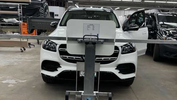 ADAS calibration taking place on a white SUV inside an automotive workshop in White Bear Lake, MN.