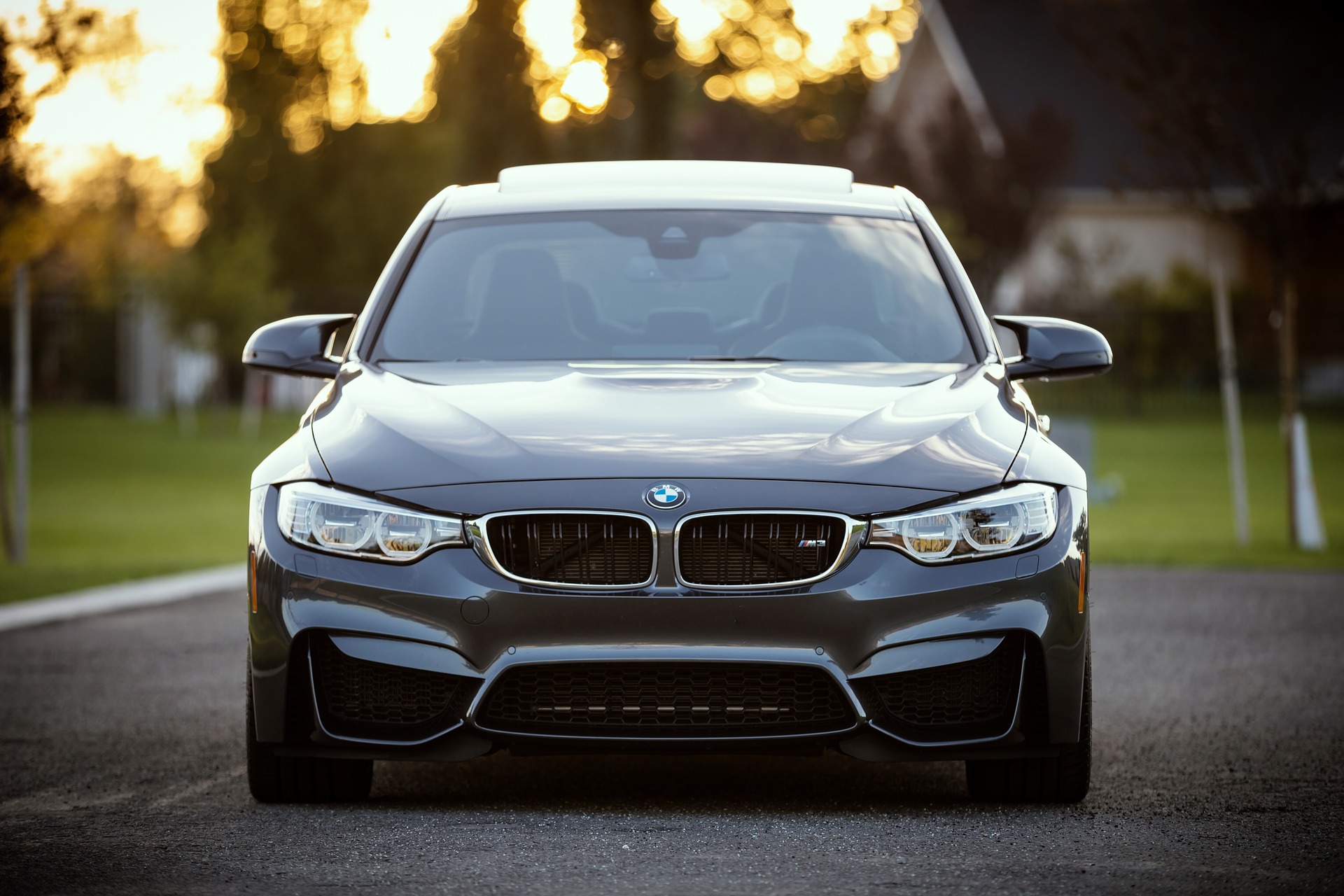 A front-facing image of a sleek, grey BMW car parked on a road in St. Paul, Minnesota.